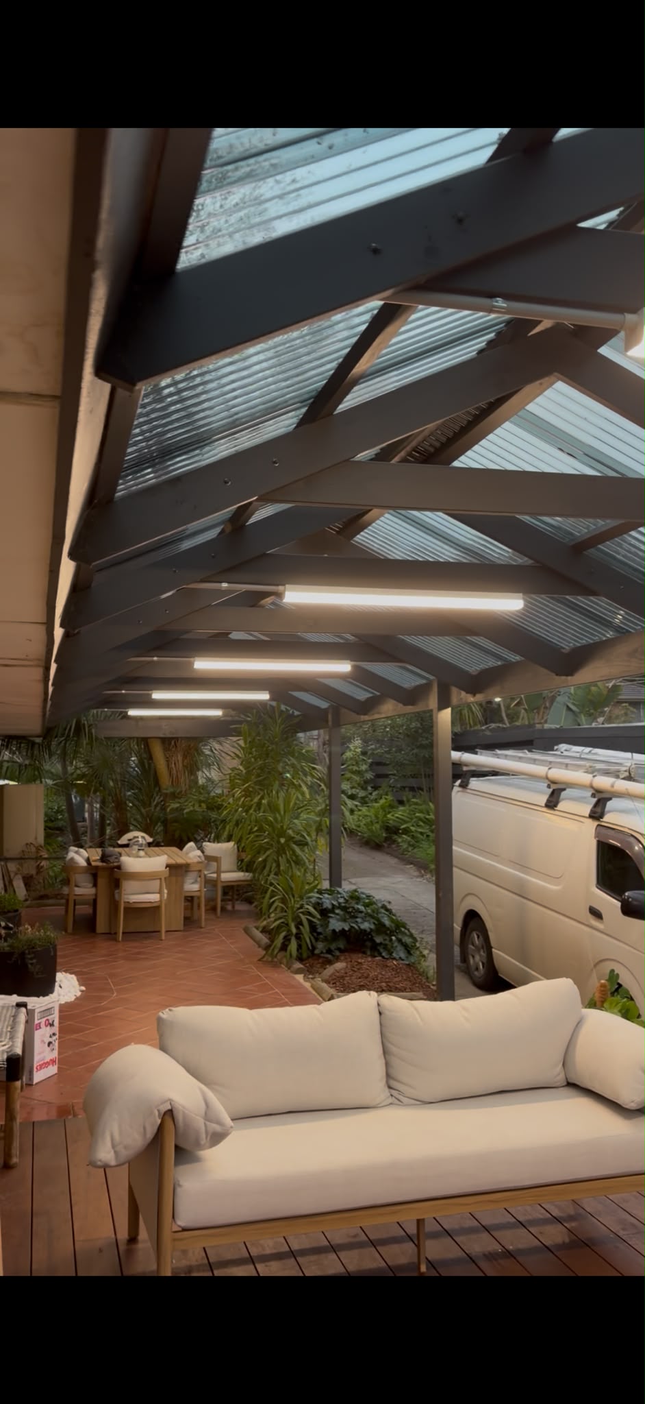Linear lighting installed beneath an outdoor pergola